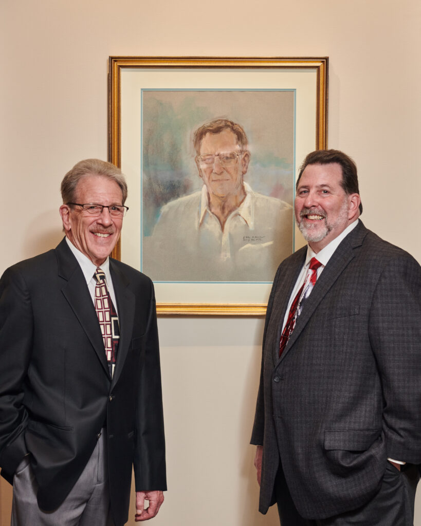 Bart Terroni, Jr. and Chris Terroni pictured with a portrait of their father, Bart Terroni, Sr.